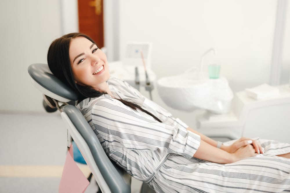 Woman sitting on a dental chair - Teeth Whitening in Seattle Woman sitting on a dental chair - Teeth Whitening in Seattle