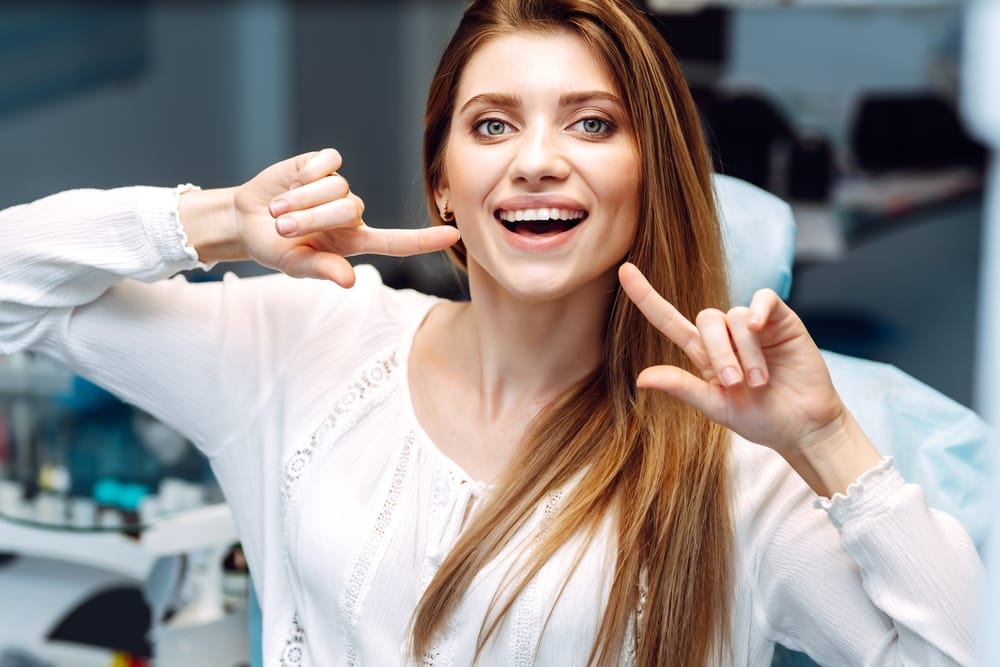 Young woman at the dentists chair during a dental procedure - Veneers in Seattle