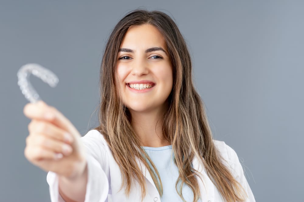 Woman holding an Invisalign in Seattle